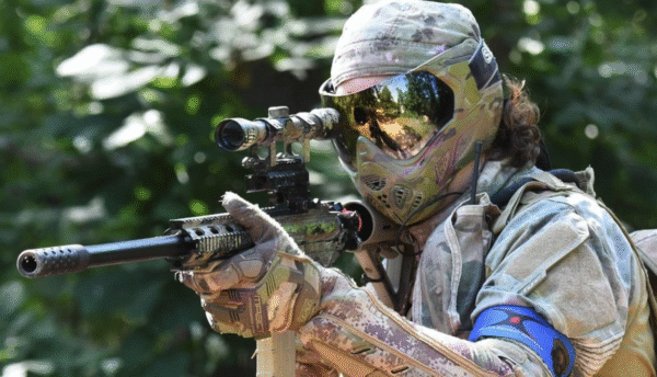 a paintball player with a sniper marker